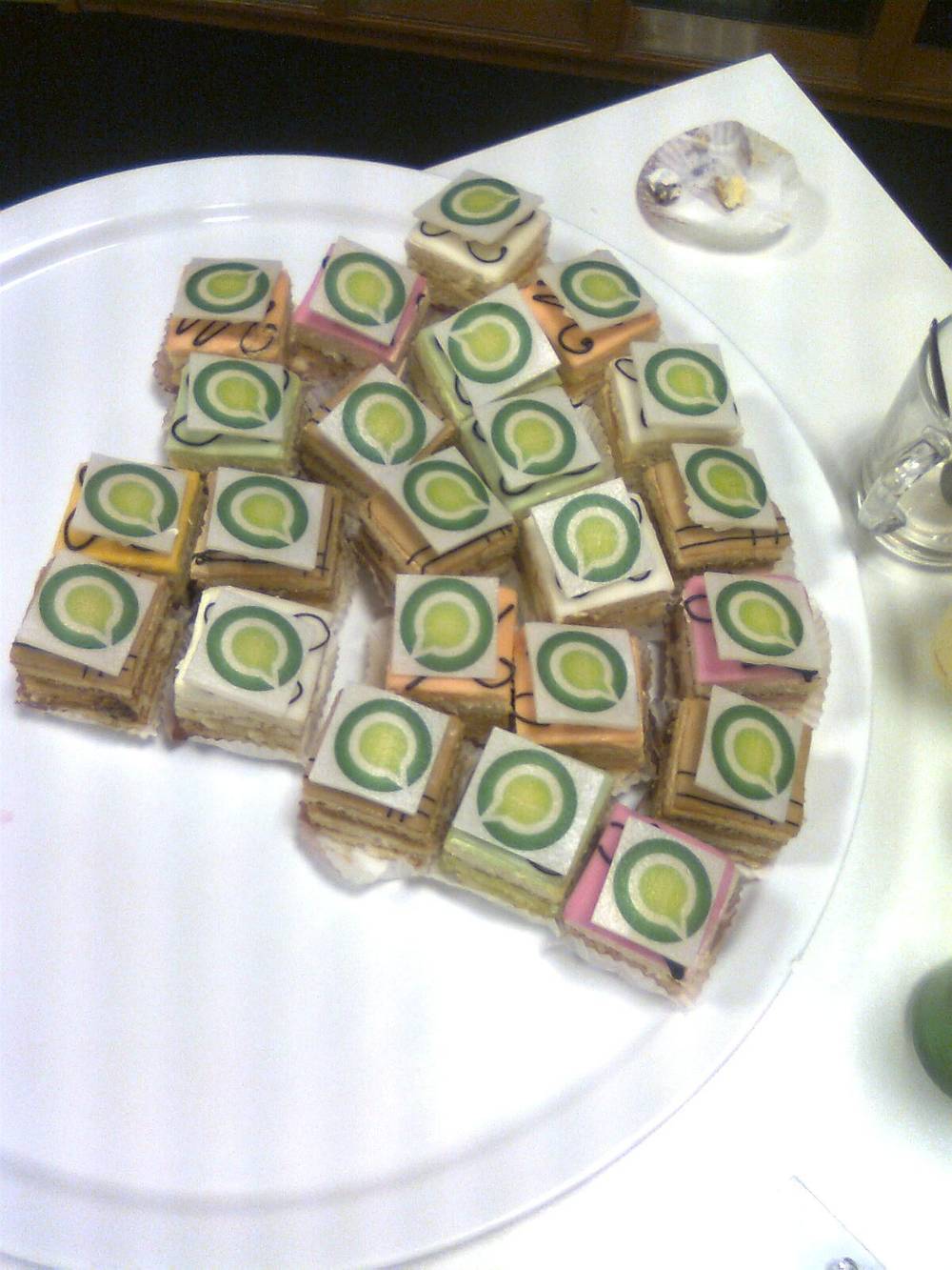 A cake sits on a table at an office gathering celebrating one year of Online Dialogue.