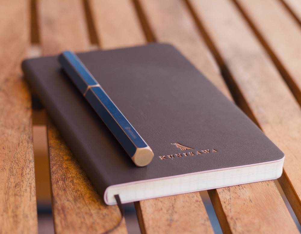 A photo of a notebook and a pen