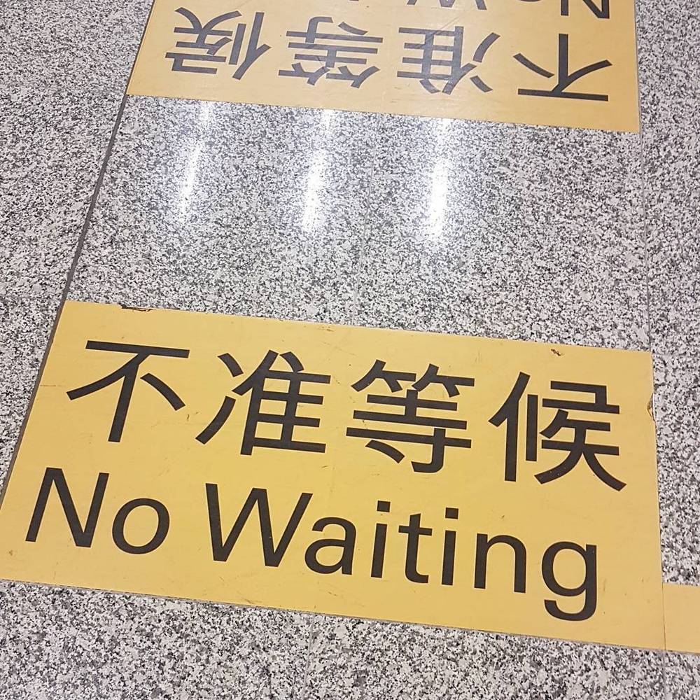 A floor sign in Chinese and English reading "No Waiting."