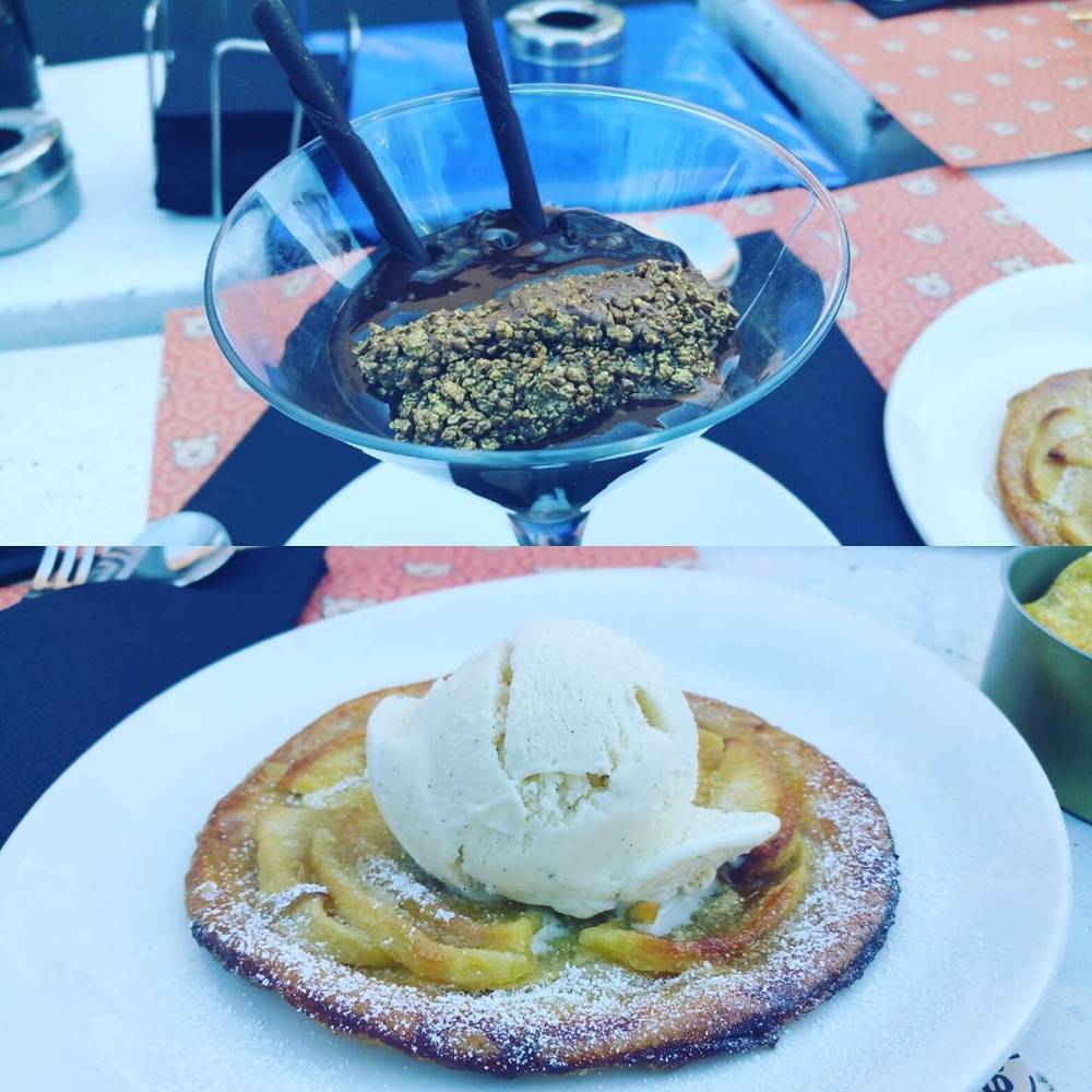 A dessert with dark sauce and toppings in a martini glass, next to a pastry topped with vanilla ice cream.