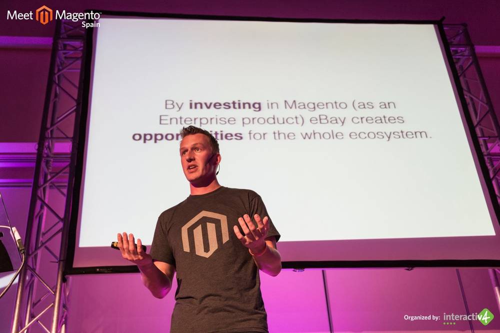 A man presents a slide about eBay investing in Magento as an enterprise product.