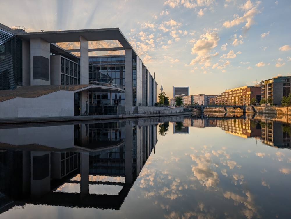 Angular modern architecture reflected in water.