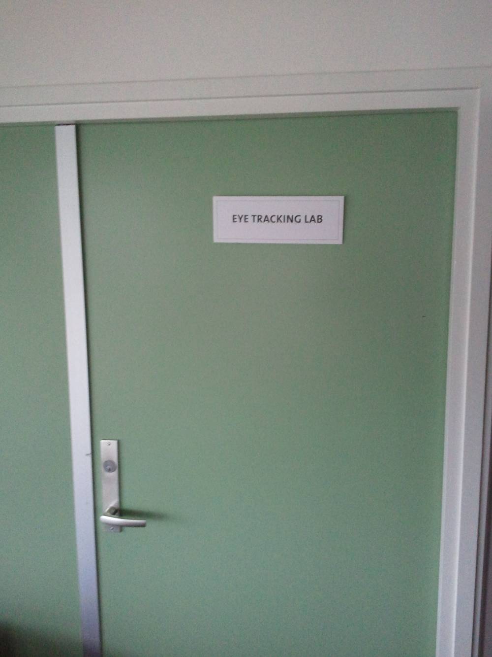 A green office door is labeled 'Eye Tracking Lab.'
