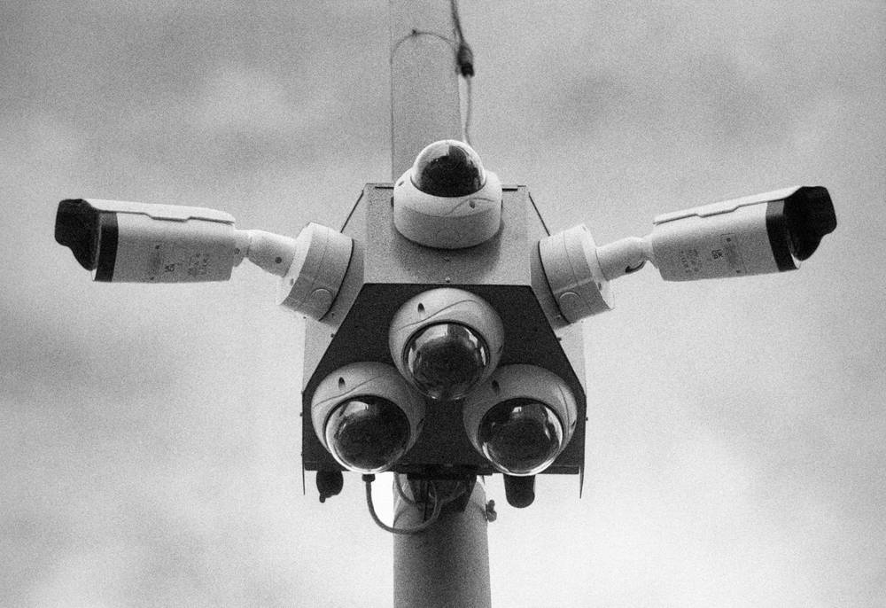 security cameras on a pole outside an apartment building