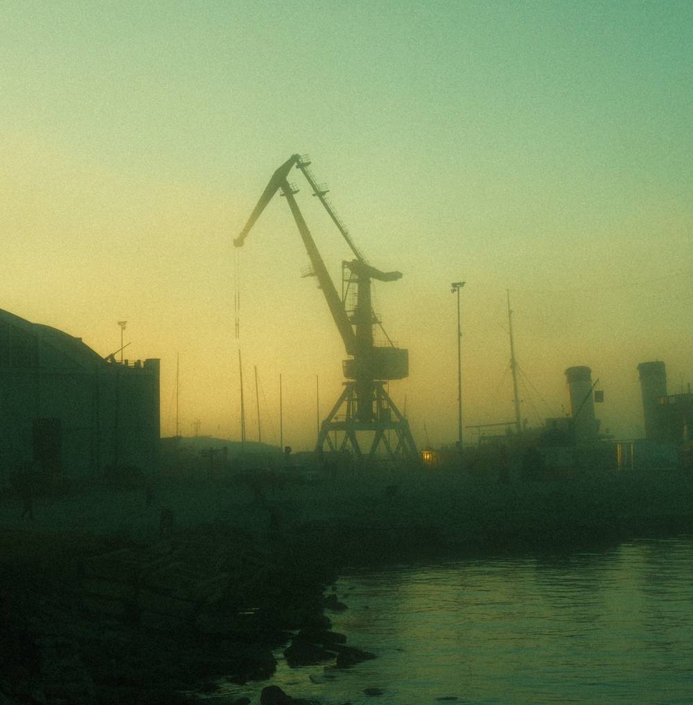 Industrial crane visible through evening for in Lennusadam