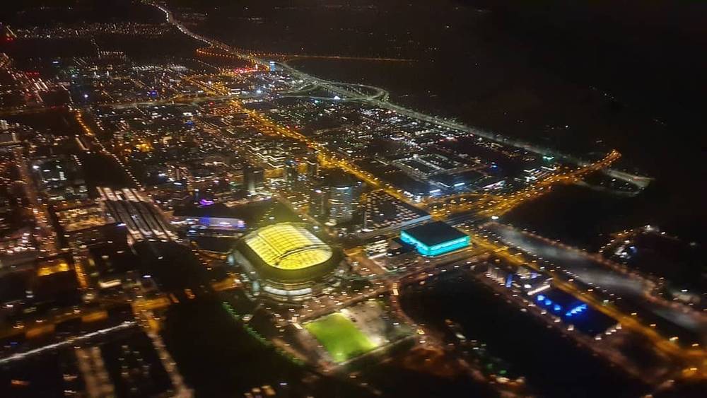 Aerial nighttime view of the Las Vegas Strip lit up with colorful lights.