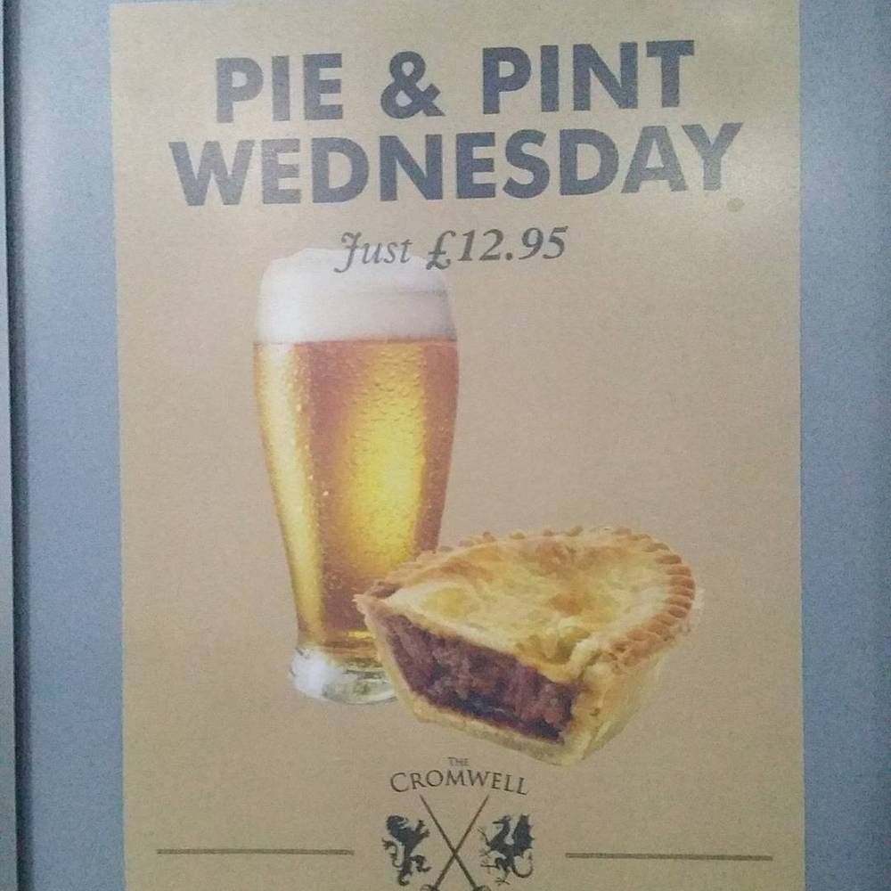 A pub sign reading 'Pie & Pint Wednesday, Just £12.95' with an illustration of a beer glass and pie, branded 'The Cromwell'.