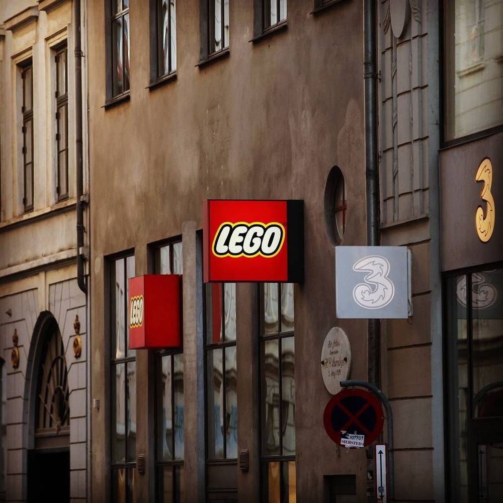 The exterior of a Lego store with the brand's logo on a historic building facade.