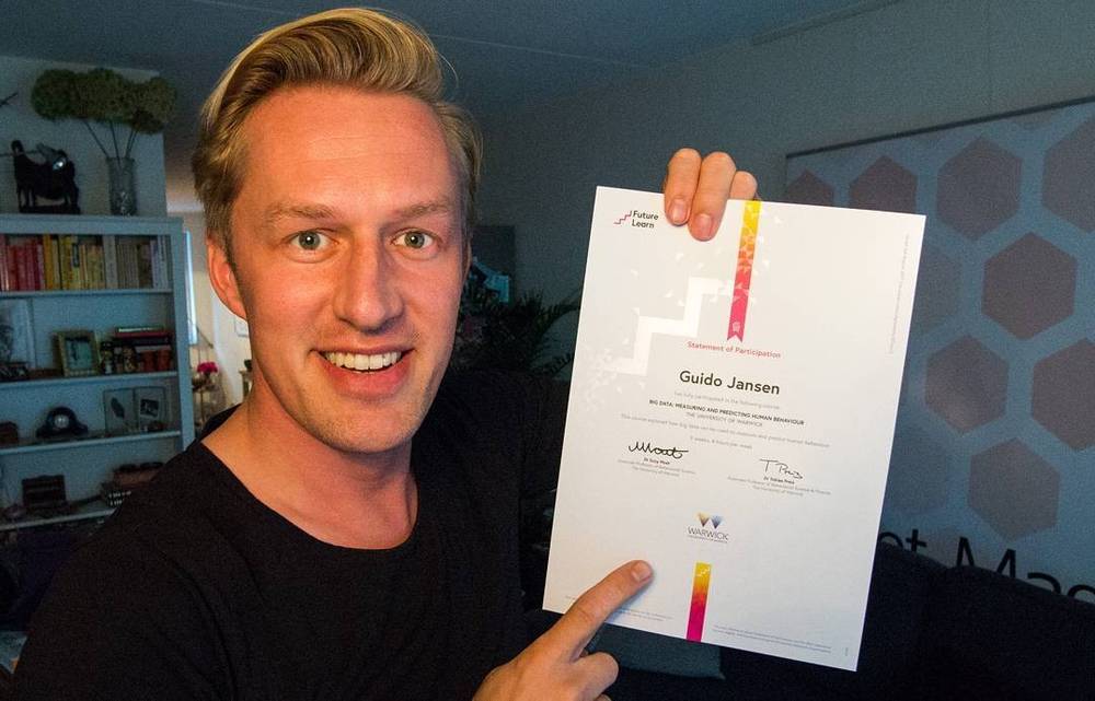 Selfie holding a certificate titled "Statement of Participation" for a FutureLearn course, name Guido Jansen visible.