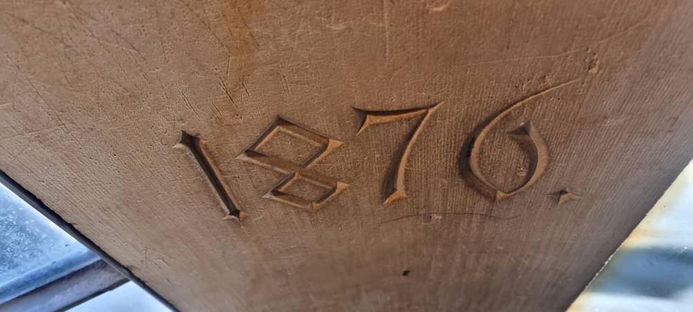 Year 1876 engraved in sandstone. Inside a spiral staircase.