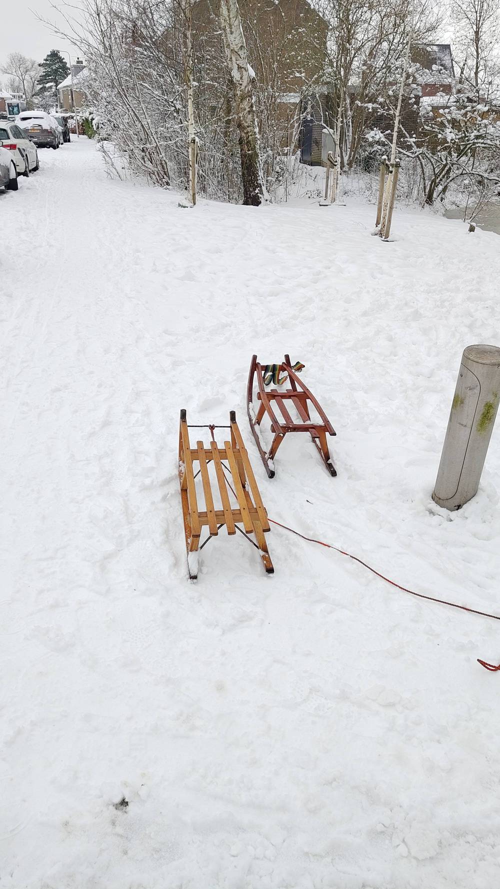 Two wooden sledges resting in the snow.