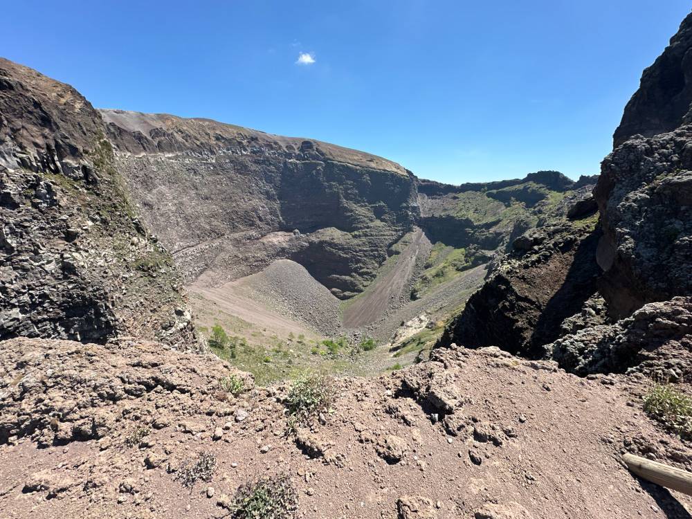 The inside of the crater - there's a lot of what looks to be dirt, sand, and/or gravel, and other rocks.