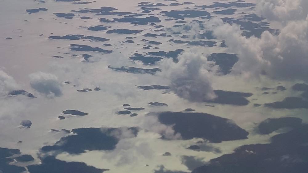 Cloud formations seen from an airplane window.