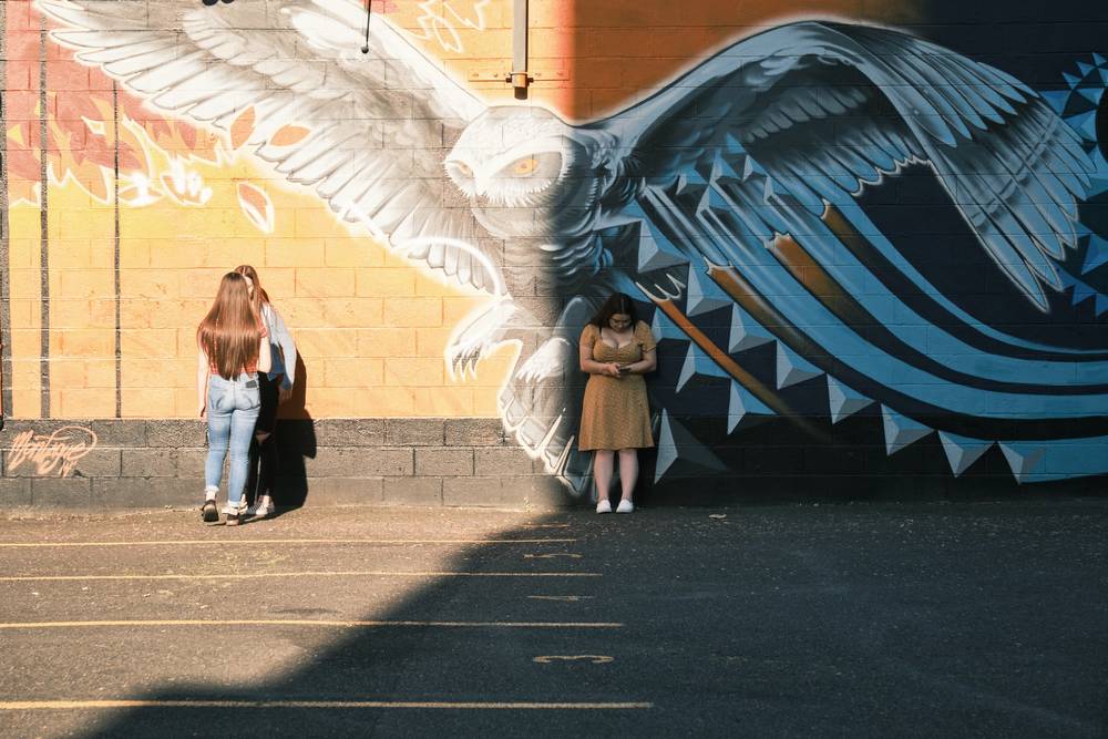 Solitary Figures Beneath Portland's Watchful Wings
