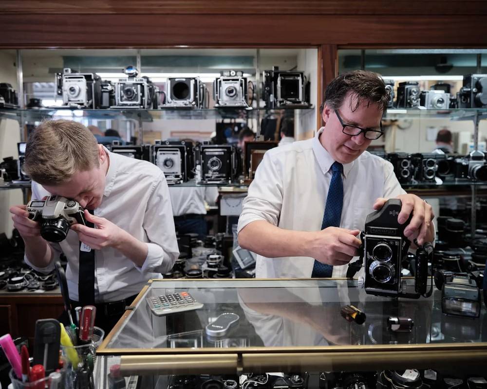 Craftsmen Among Vintage Cameras in Portland Shop