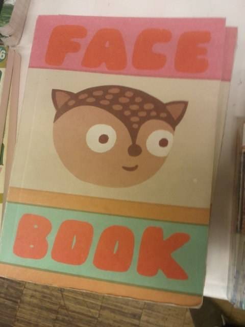 A paper craft box is labeled 'FACE BOOK' as a playful pun.