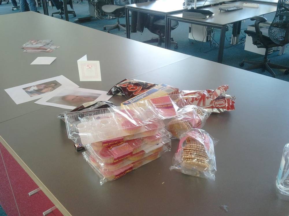 Snack bags and photos scattered across an office table.