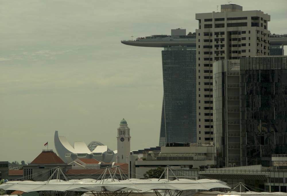 Marina Bay Sands and the ArtScience Museum's lotus-shaped roof rise above the old Clock Tower.