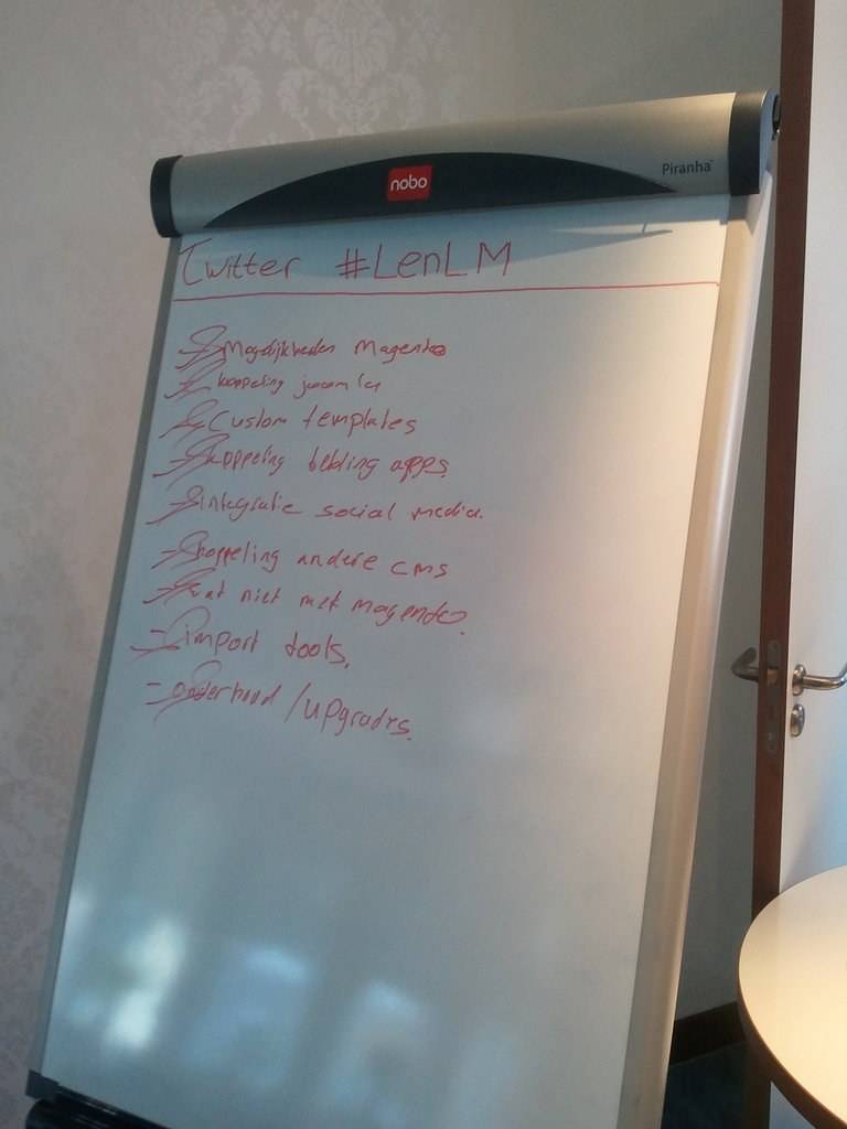 A flipchart lists notes about Twitter and other topics from a workshop discussion.