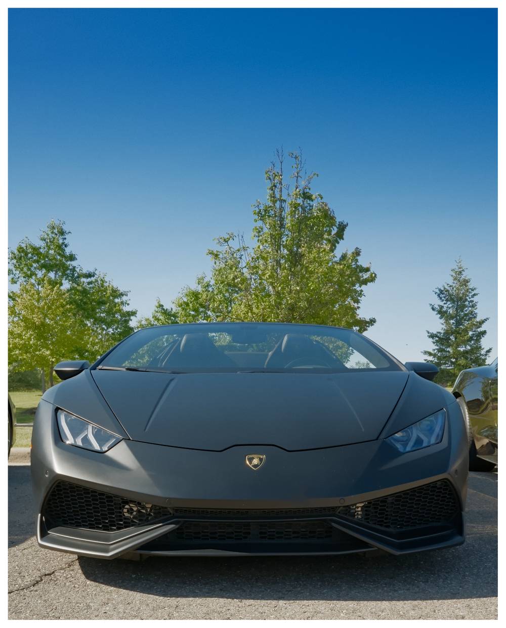 Front view of a matte black Lamborghini Huracan