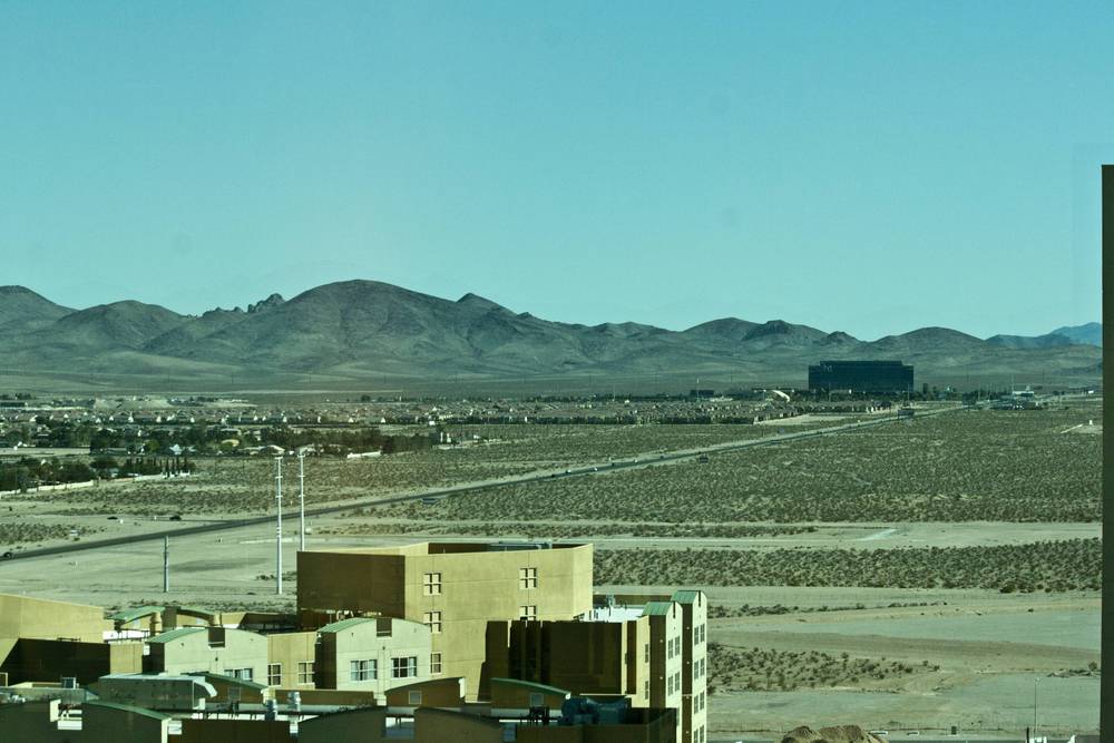 Desert hills and low buildings near Las Vegas seen from a hotel viewpoint.