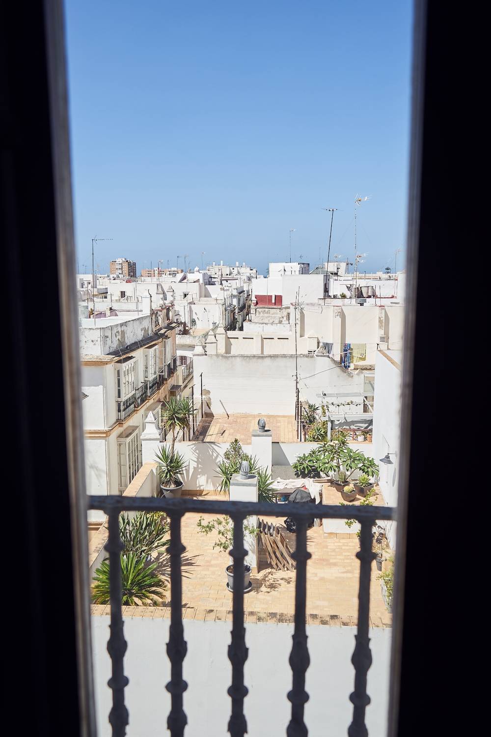 view from inside through the blinds onto the beautiful city of cadiz 