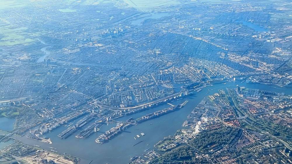 Aerial view of a river winding through a city and surrounding countryside.
