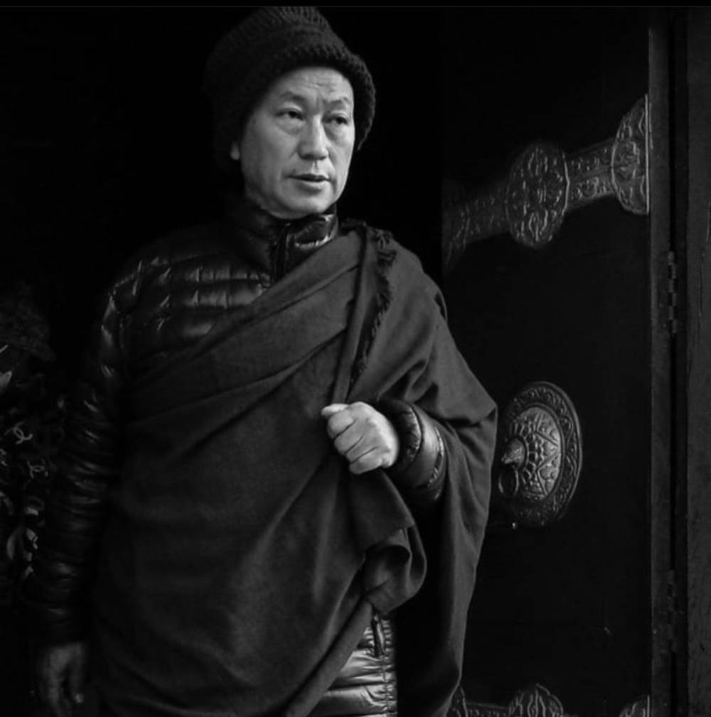 Monk in winter exiting a Mani Khorlo/Mani Chaka
